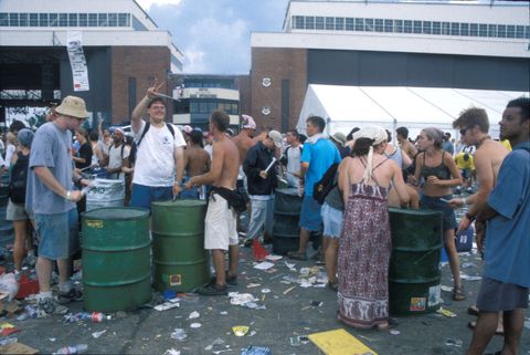 concert fans drumming on garbage cans at woodstock 99