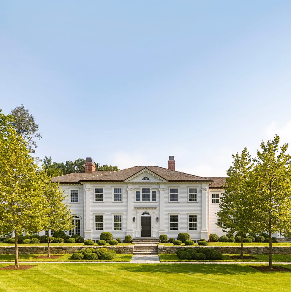 home in concord, massachusetts design by dan gordon landscape architects mounded boxwoods and an allée of london plane trees quietly enhance the home’s historic grandeur