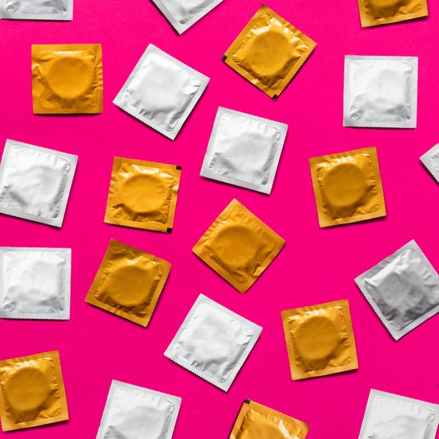 condoms in pink background, top view