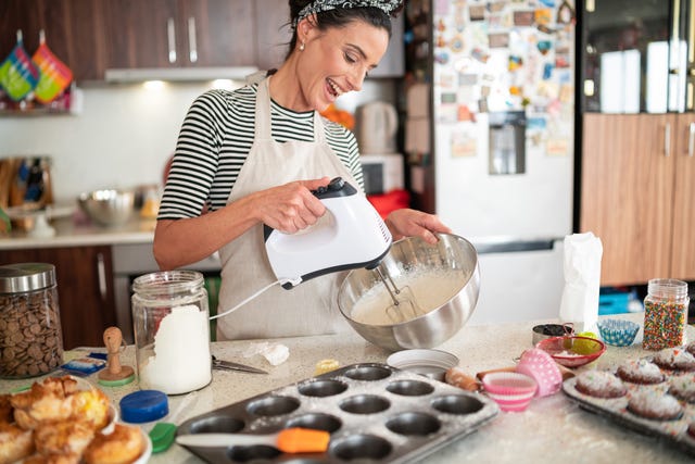 Confectioner woman making delicious cream for cupcakes