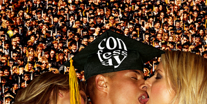 a man in a graduation cap making out with two women