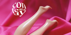 plastic doll legs on a satin pink background