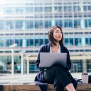 confident businesswoman working with laptop in the financial district