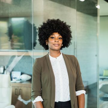 confident female lawyer stands outside office