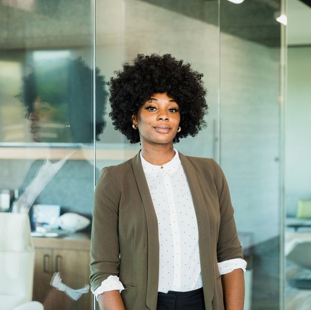 confident female lawyer stands outside office