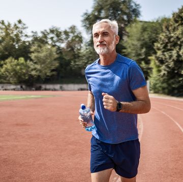 confident mature athlete on track field