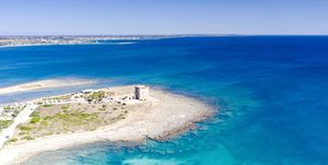 aerial view of the defensive lookout tower torre chianca by the sea, torre lapillo, porto cesareo, lecce province, salento, apulia, italy