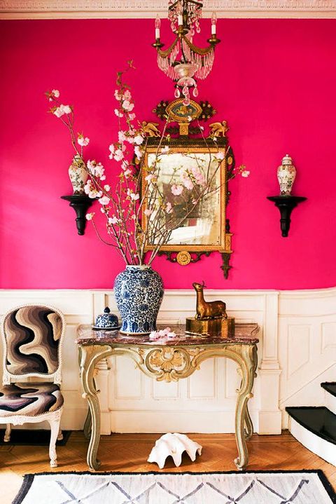 pink hallway with console table and flowers
