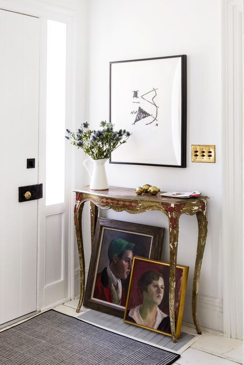 eclectic entryway with antique console table