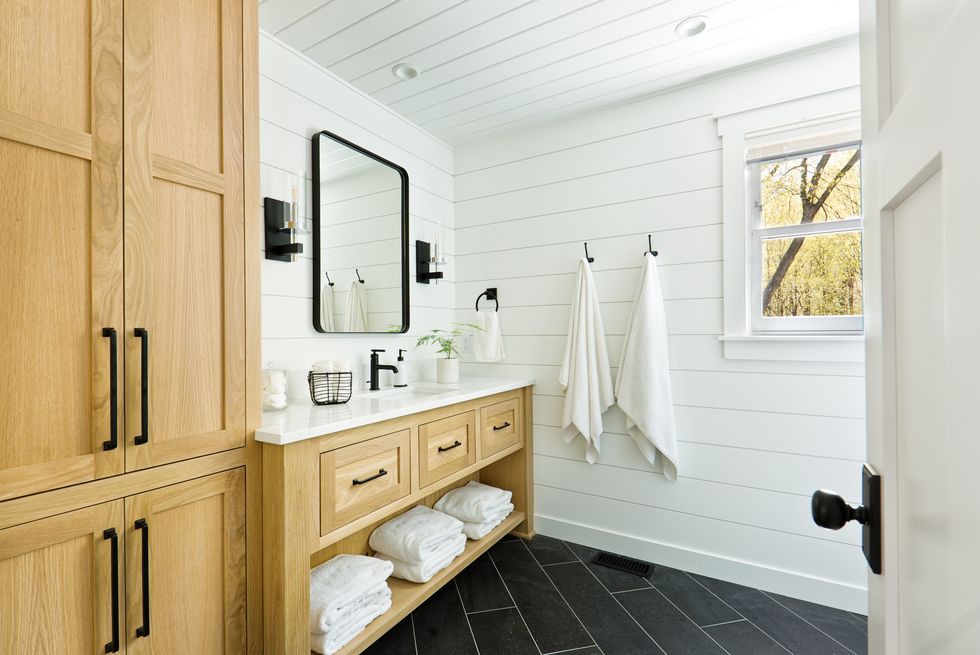contemporary country home cabin bathroom design with vanity and linen storage