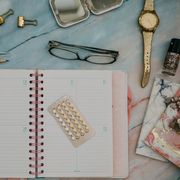 contraceptive pills calendar and feminine items in desktop