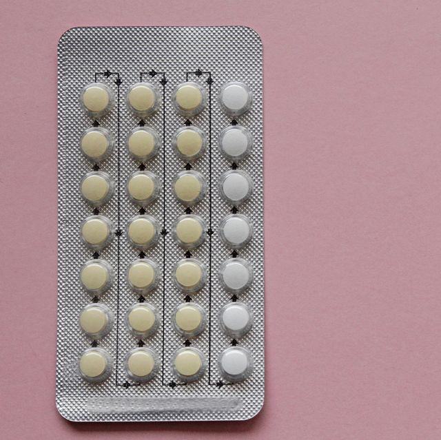 contraceptive pills in blister pack on pink background
