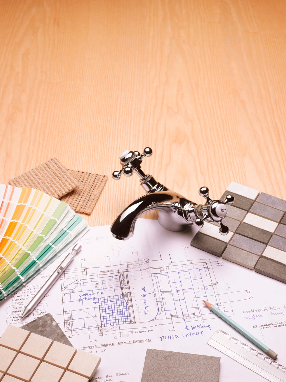 paint and tile samples, faucet, and blueprints for bathroom