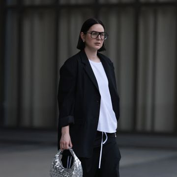 dusseldorf, germany march 18 maria barteczko seen wearing victoria beckham black oversized aviator glasses, wendykei black oversized blazer, wendykei white asymmetric shirt, wendykei black striped wide leg pants, converse taylor black all star chucks, asos silver metallic woven bag, on march 18, 2023 in dusseldorf, germany photo by jeremy moellergetty images