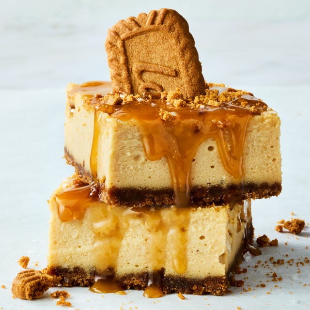 cheesecake bars topped with caramel and crumbled biscoff cookies