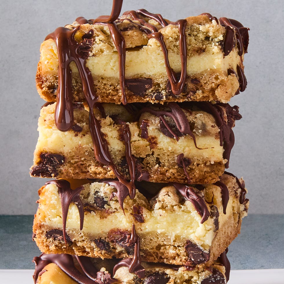 cheesecake bars with a cookie bottom and top layer drizzled with chocolate