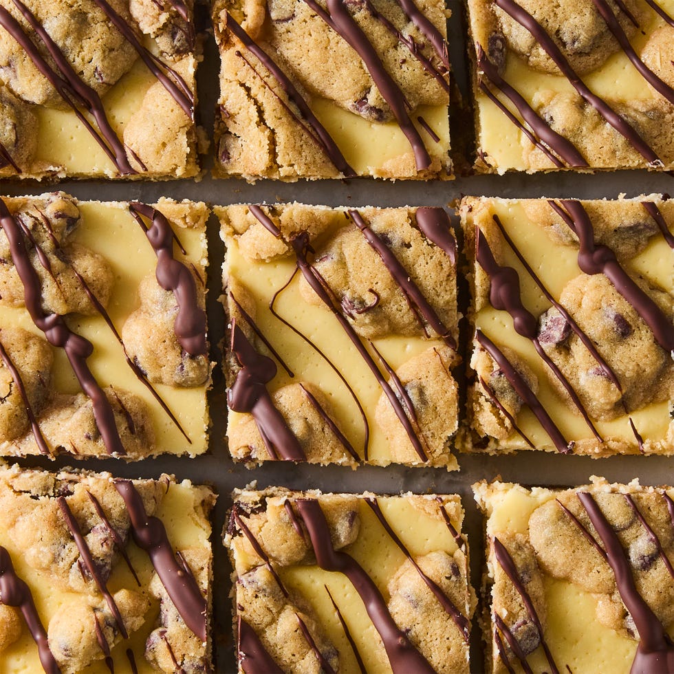 cheesecake bars with a cookie bottom and top layer drizzled with chocolate