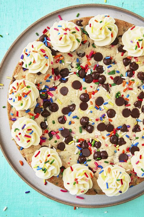 chocolate chip cookie cake decorated with buttercream and sprinkles