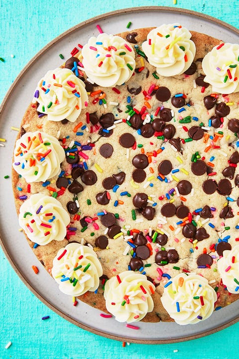 chocolate chip cookie cake decorated with buttercream and sprinkles