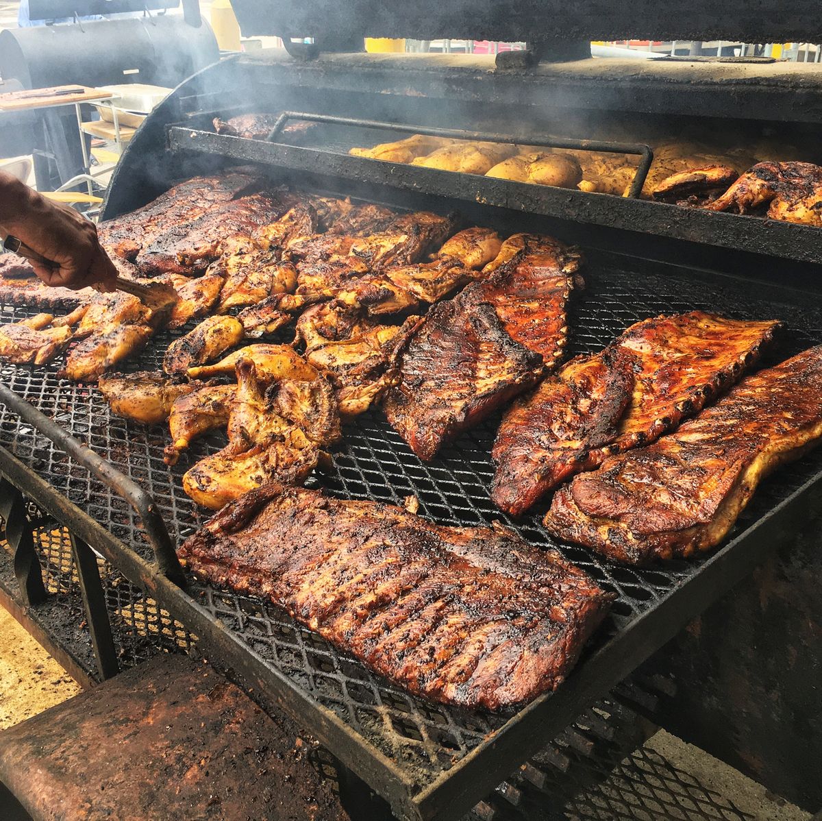 https://hips.hearstapps.com/hmg-prod/images/cooking-chicken-and-slabs-of-ribs-on-barbecue-grill-royalty-free-image-1625609727.jpg?crop=0.694xw:1.00xh;0.231xw,0&resize=1200:*