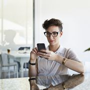 Cool businesswoman scrolling on phone