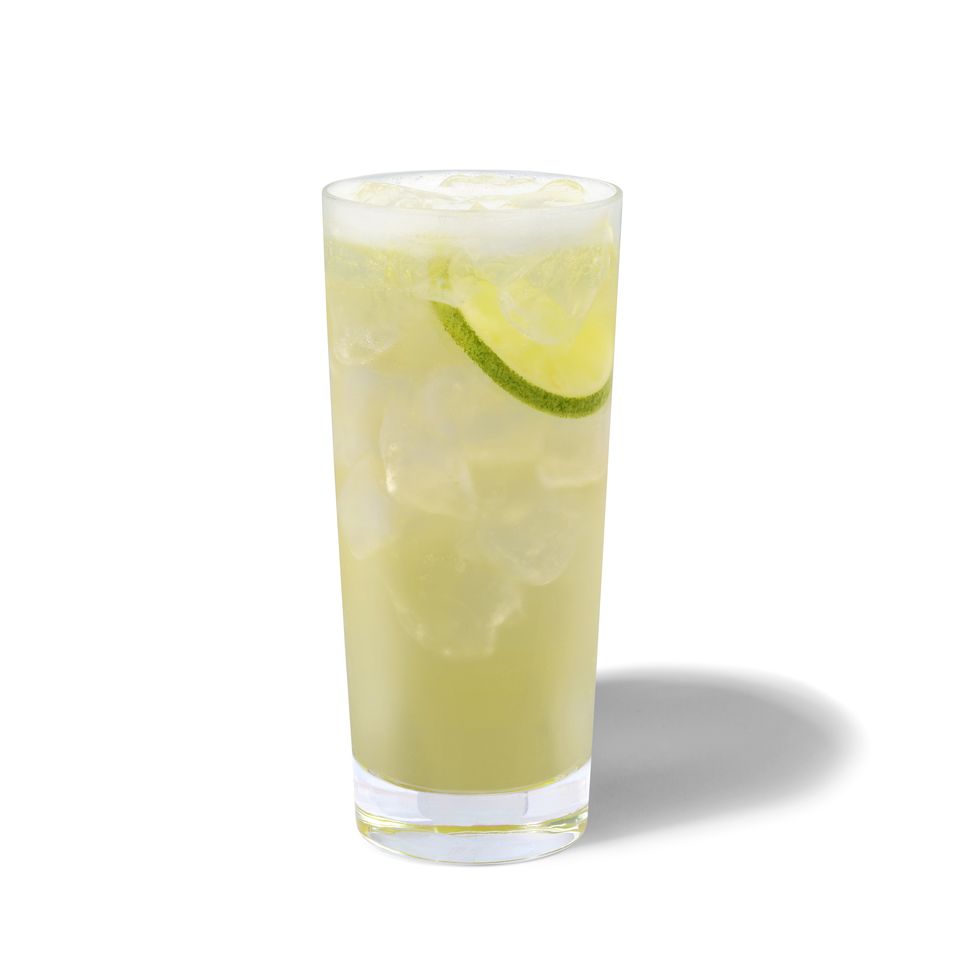 starbucks cool lime refresha drink pictured in a glass with ice and limes