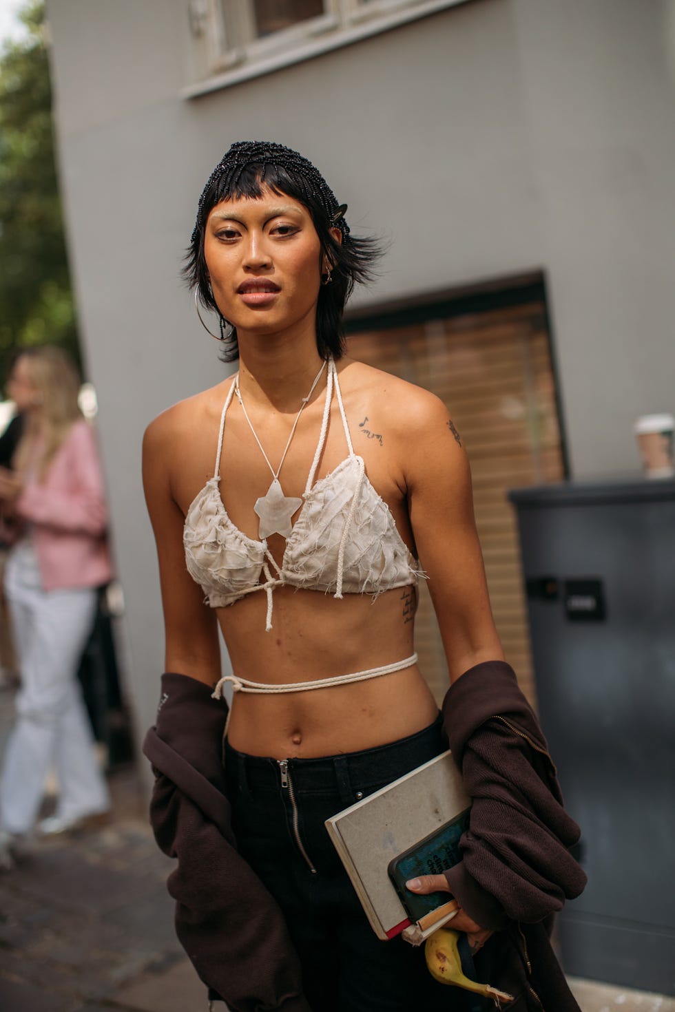 street style star with choppy brunette bob and baby bangs copenhagen fashion week bob haircut
