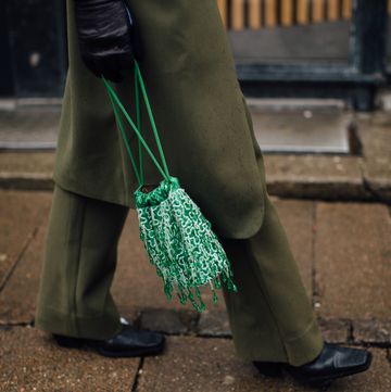a person carrying a green bag
