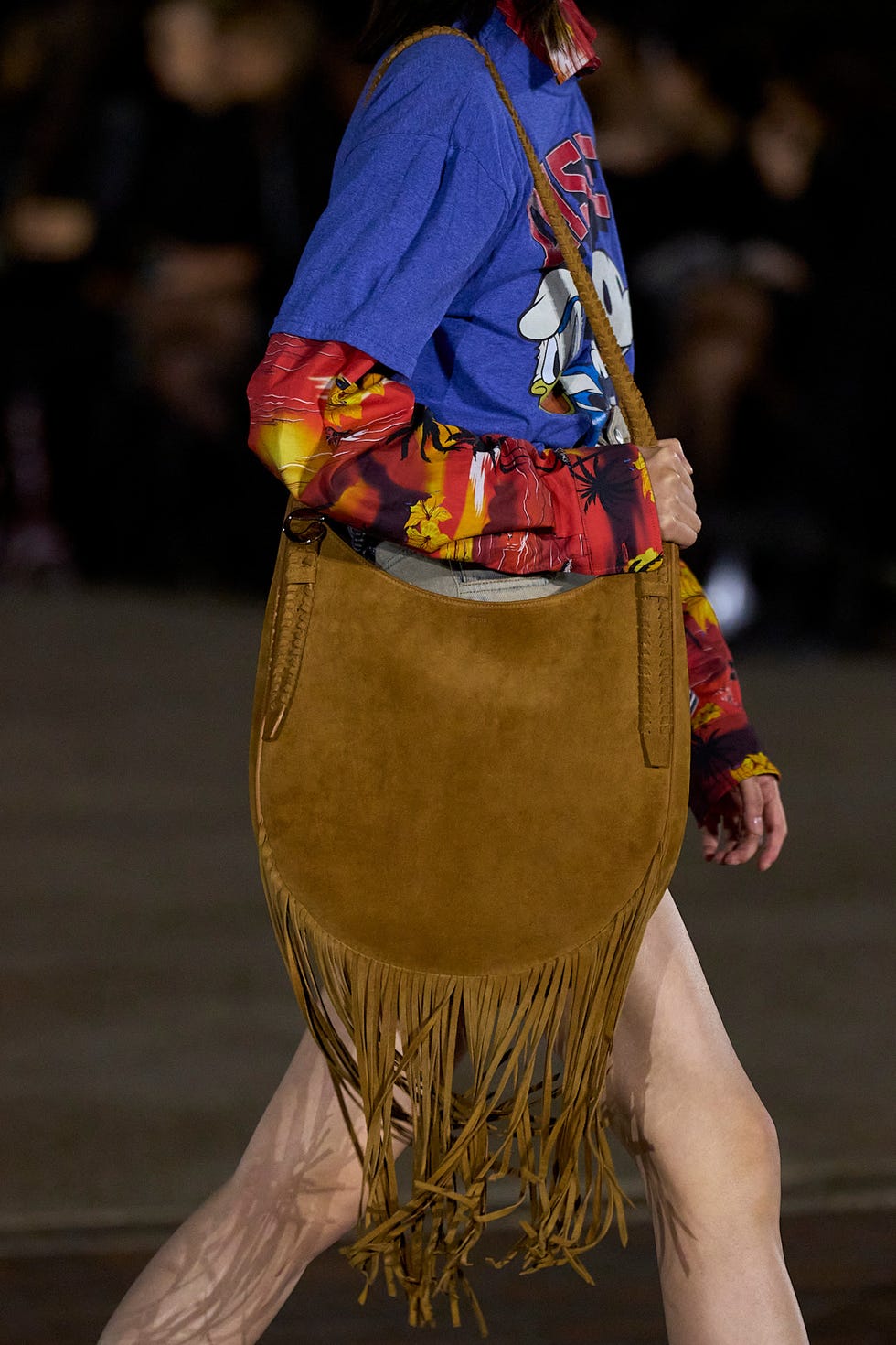 Model showcasing a fringe handbag