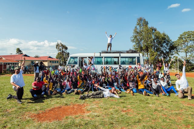 a group of people sitting on the grass