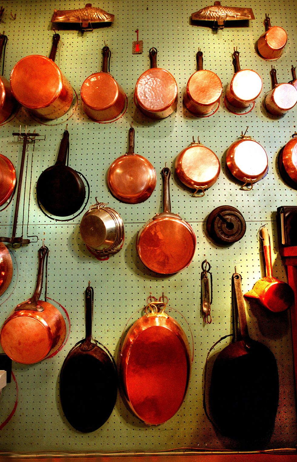 copper pots hang in julia child's kitchen