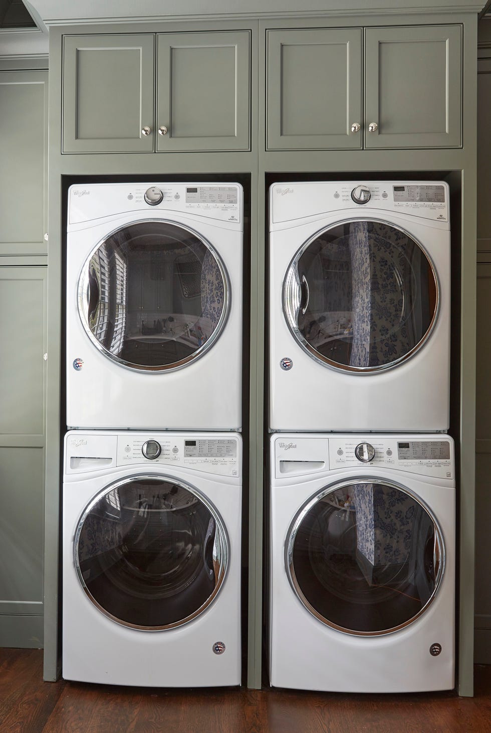 set of two washer and dryer, stacked with green cabinets