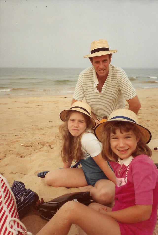 family gathering at the beach with children and an adult