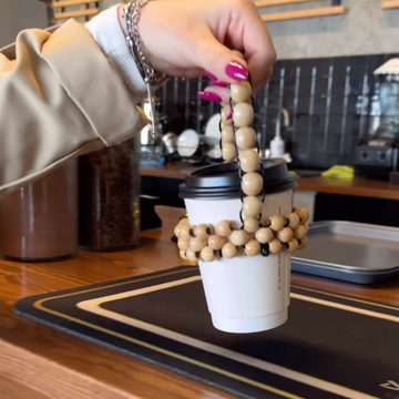 a person pouring a liquid into a cup