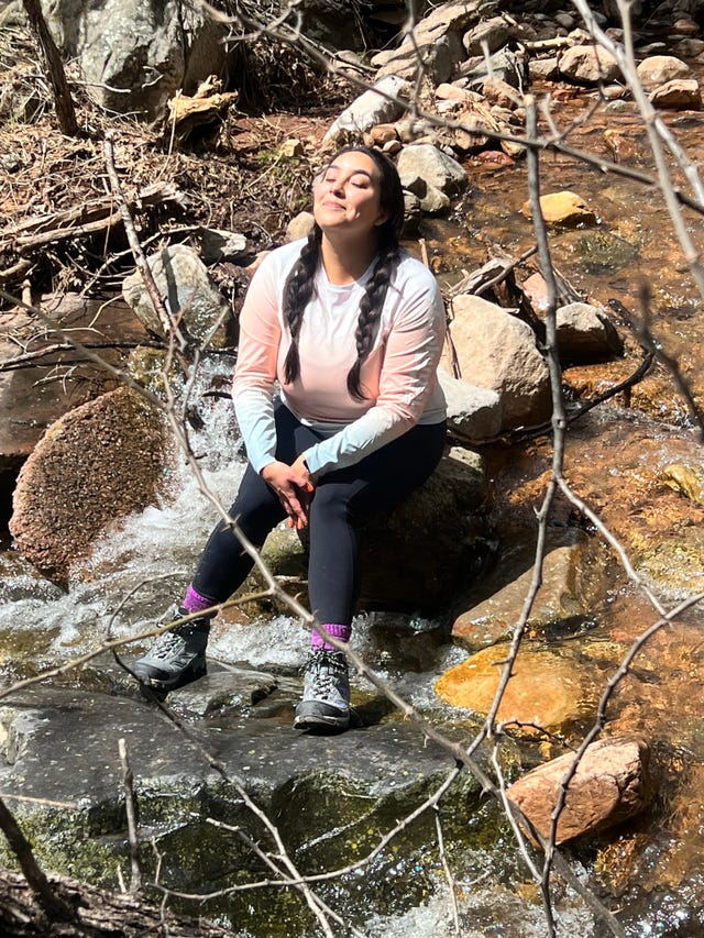 rebecka vasquez sitting on rock