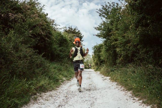 a man running on a dirt road