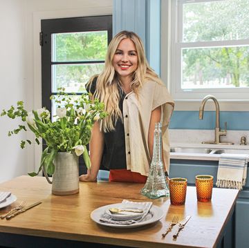 show host mary welch stands in homeowners sam johnson and jamison smith's newly renovated kitchen, where she took their entirely white space and made it pop with parisian inspiration, as seen on breaking bland, season 1