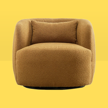 a tan chair against a yellow background