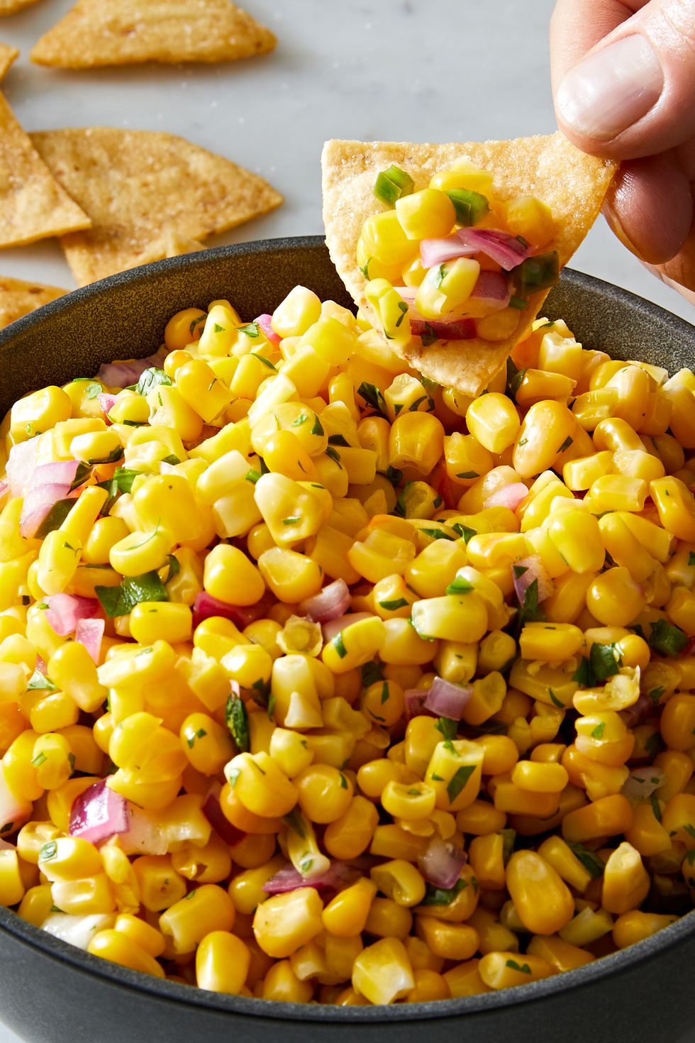 copycat chipotle corn salsa with corn, diced red onions, jalapeño and fresh cilantro