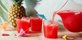 red beverage poured into a cup with an umbrella