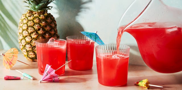 red beverage poured into a cup with an umbrella