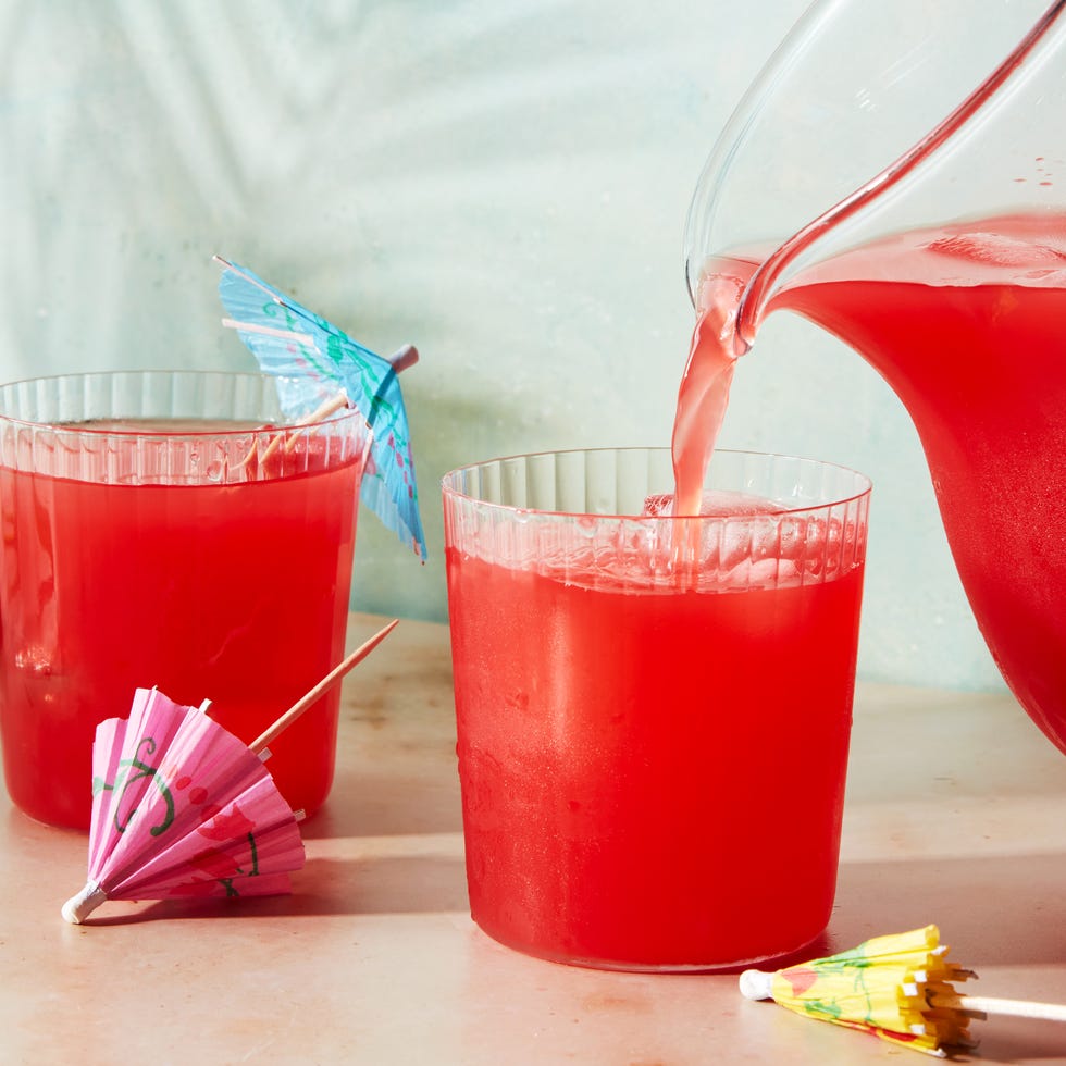 red beverage poured into a cup with an umbrella
