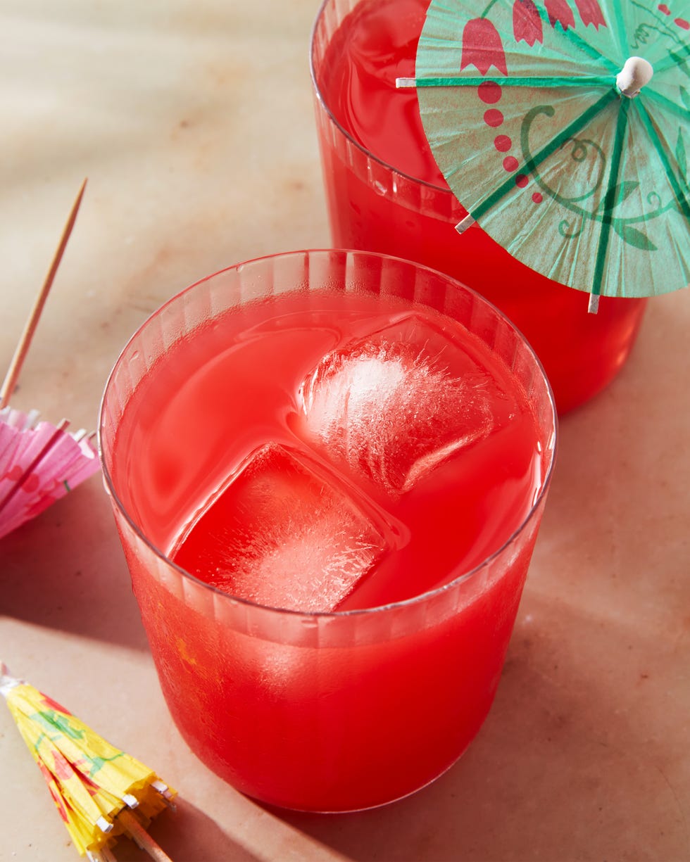 red beverage poured into a cup with an umbrella