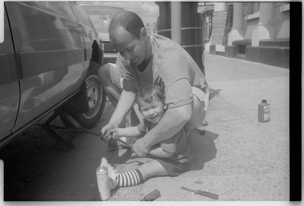 an adult and a child working together to repair a vehicle