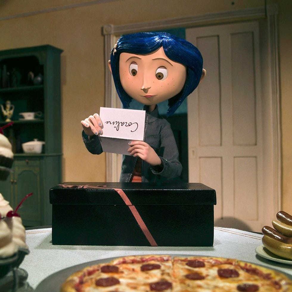 a character holding a card while standing in front of a box on a table with food items