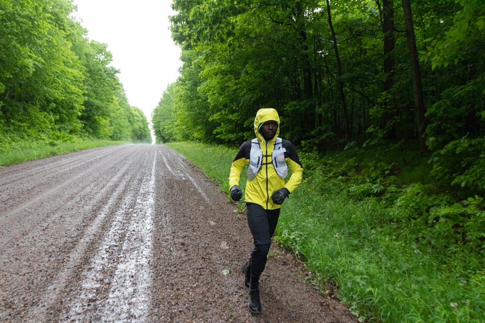 coree woltering runs along the ice age trail in the rain as he’s going after the fastest known time on the route