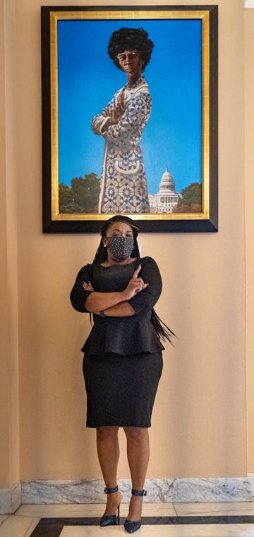 cori stands in front of shirley chisholm portrait