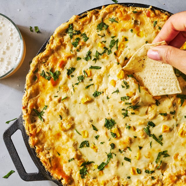 hot creamy corn dip in a cast iron skillet with tortilla chips