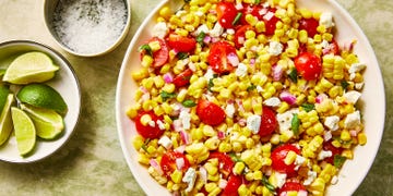 corn, chopped tomatoes, feta and basil in a bowl