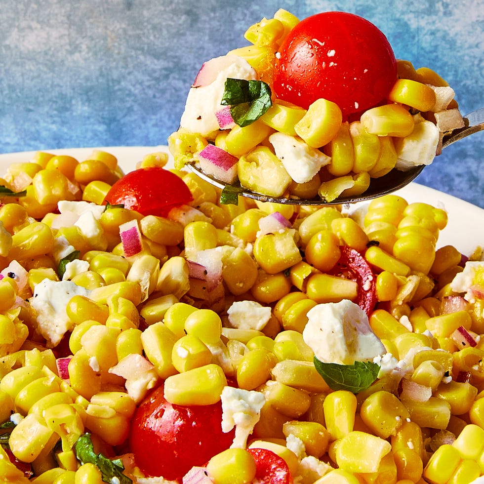 corn, chopped tomatoes, feta and basil in a bowl